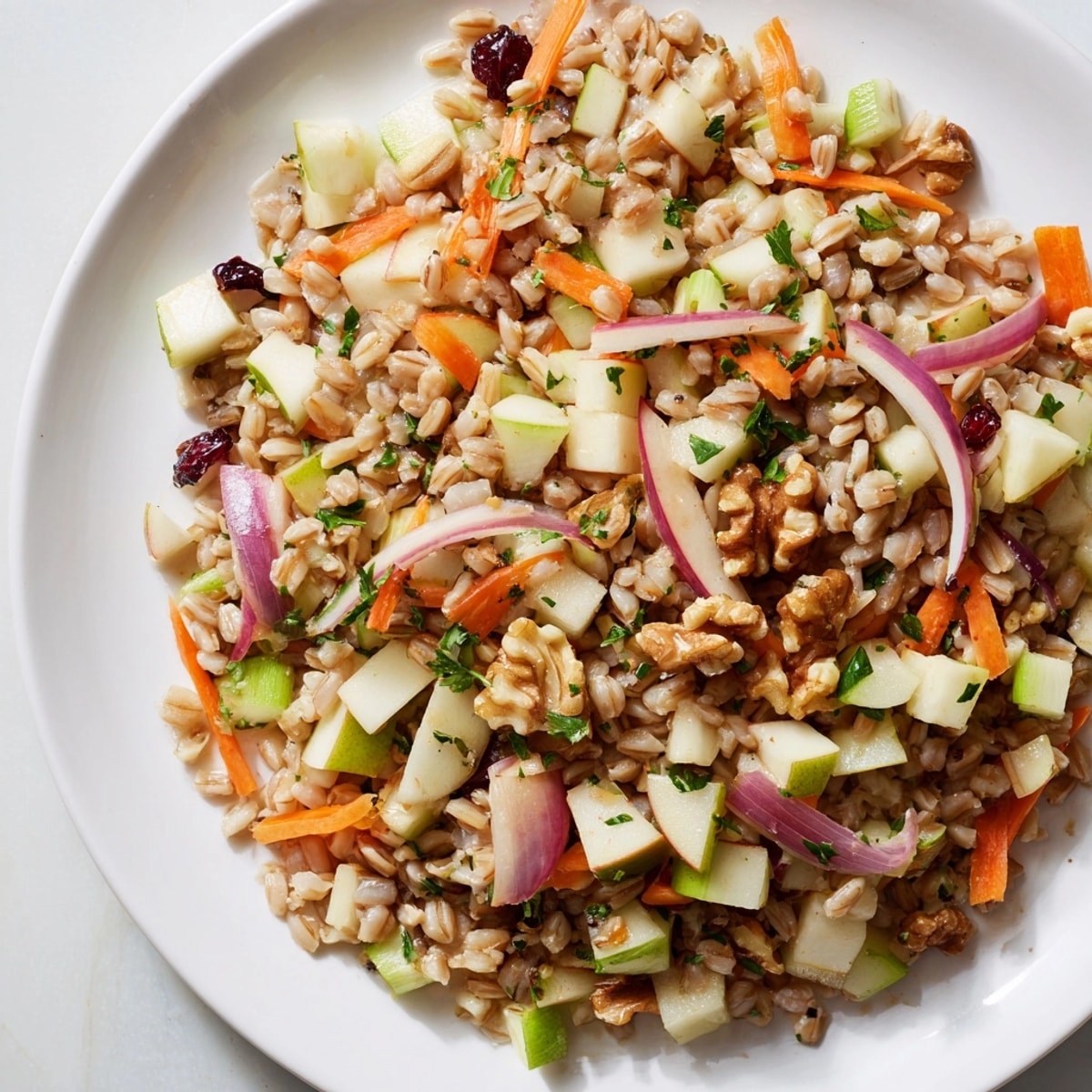 Golden Farro Apple Crunch Salad, topped with walnuts and red onion, drizzled in lemon-honey.