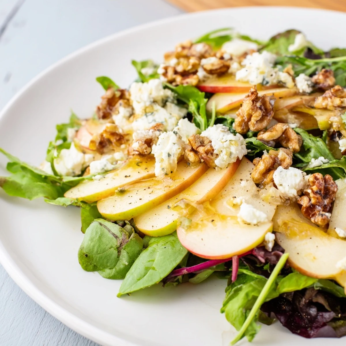 Close-up of a vibrant Seasonal Apple Salad, featuring crisp apple slices and mixed greens.