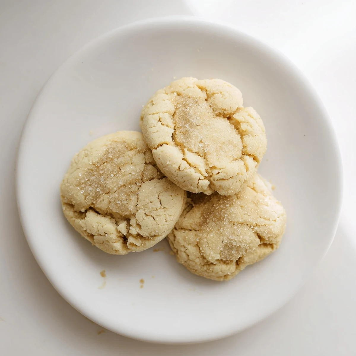 A stack of beautifully textured New Year Maple Cookies, perfectly baked with a light dusting of coarse sugar on top.