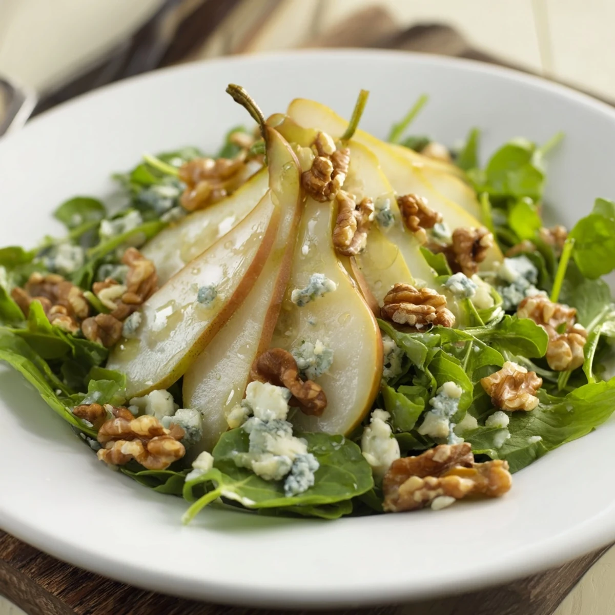Fresh, vibrant Crisp Pear Salad drizzled with tangy dressing, ready as a light appetizer on a plate.