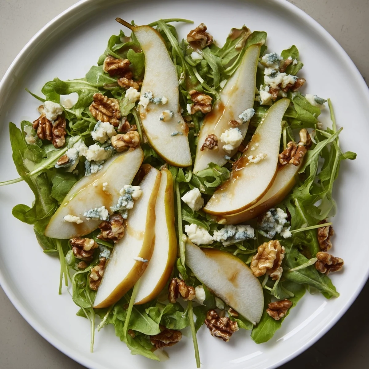 A bright and colorful Crisp Pear Salad, showcasing juicy pear slices with toasted walnuts and greens.