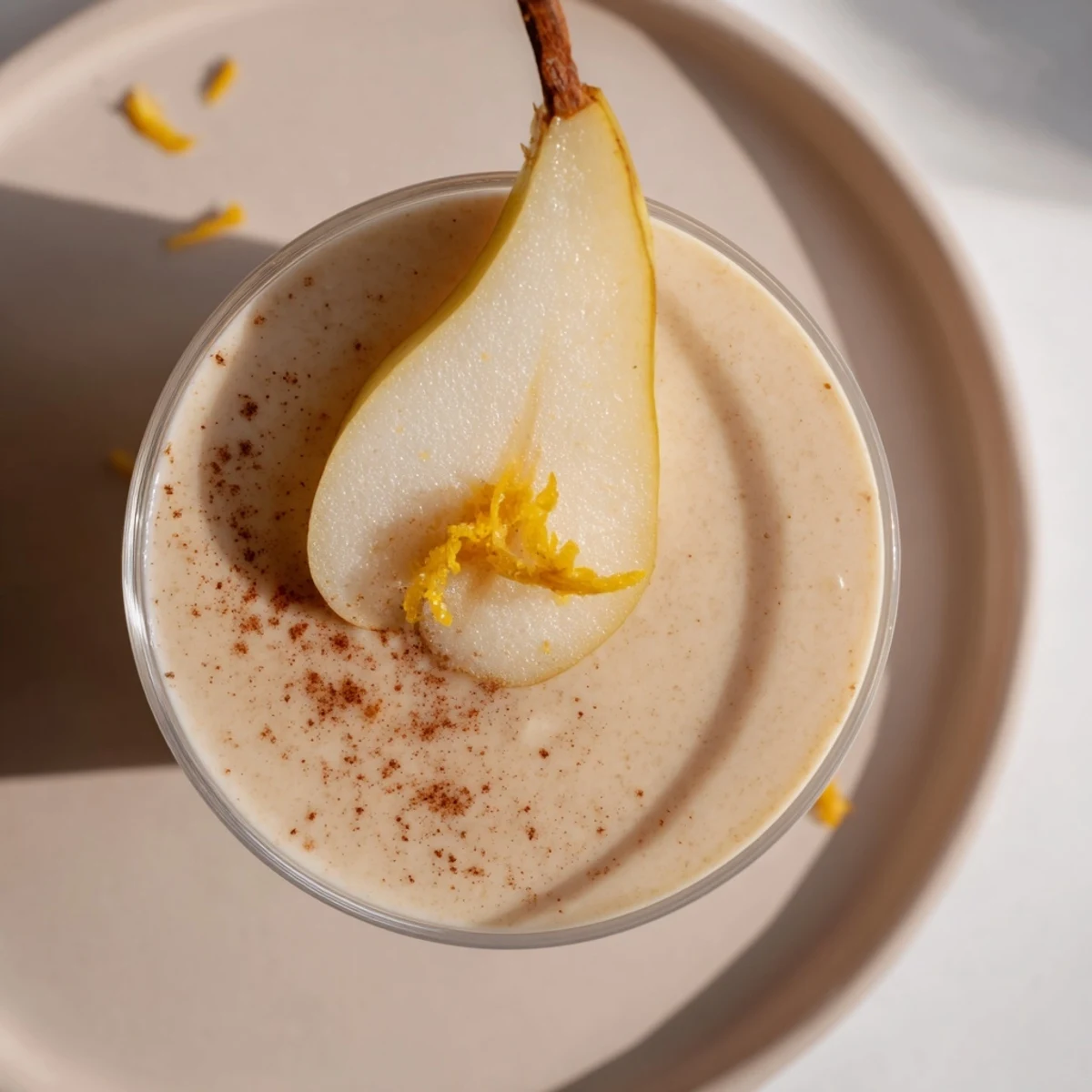 Creamy Festive Pear Smoothie garnished with cinnamon and pear slices, perfect for holiday breakfasts.
