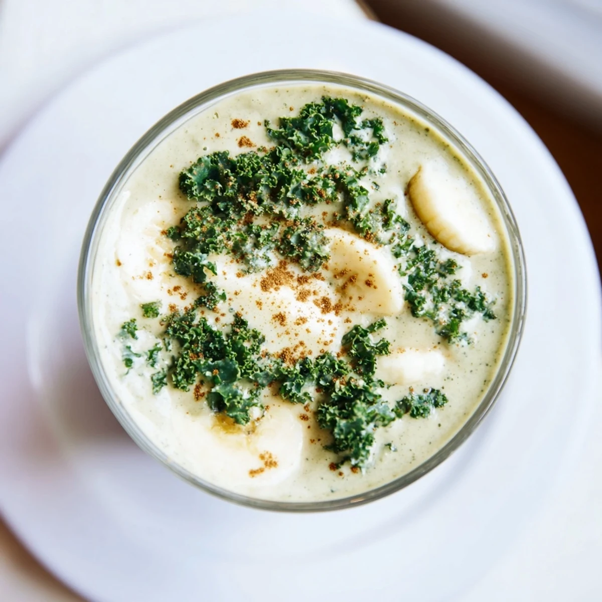 Bright green Winter Kale Smoothie, garnished with a few kale leaves, ideal for a wholesome breakfast.