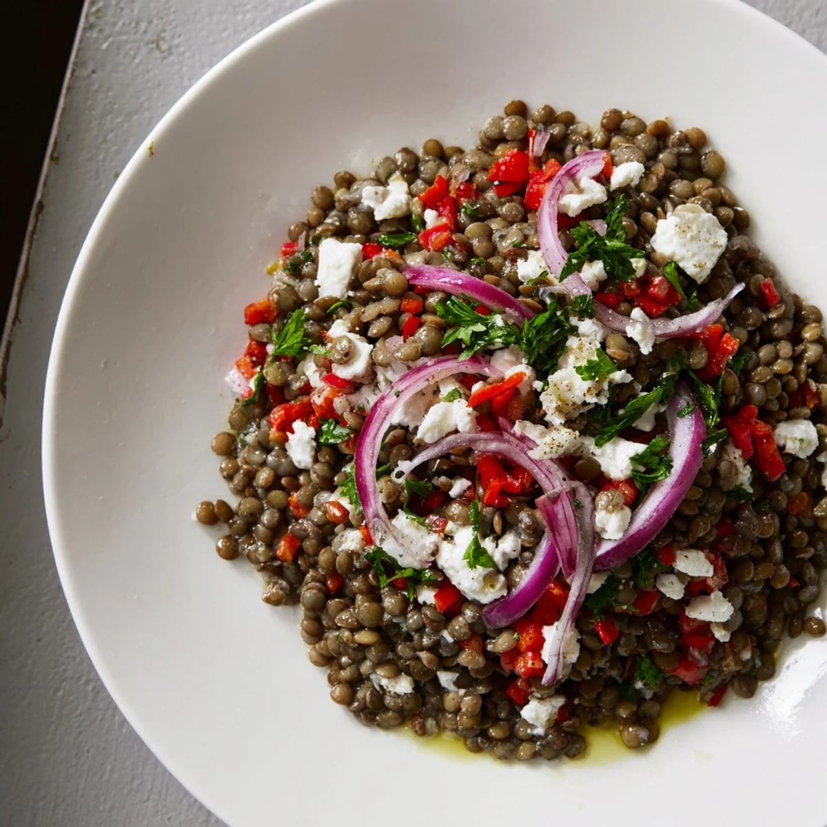 A vibrant bowl of Festive Lentil Salad, tossed with herbs and colorful vegetables for summer.