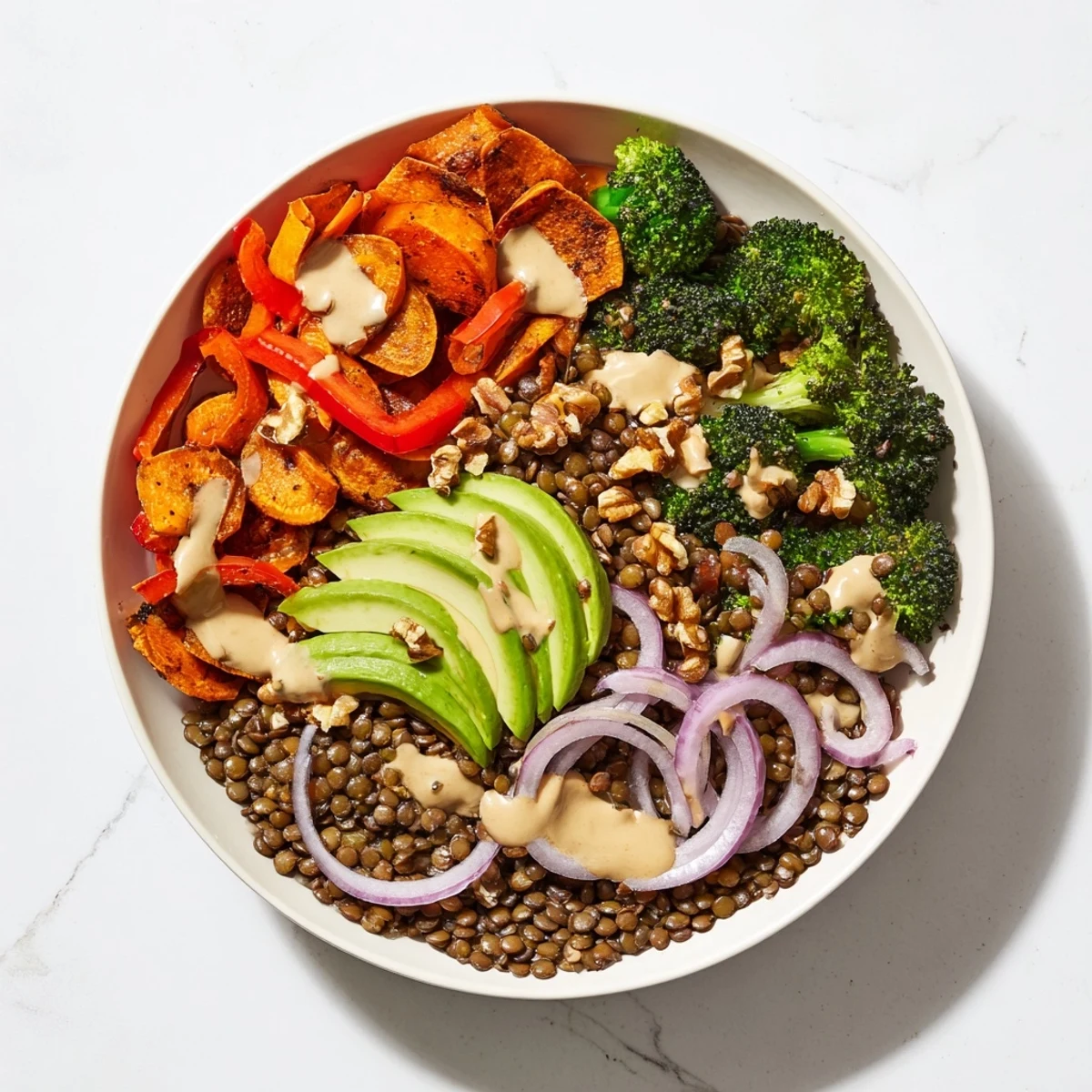Picture a tasty Wholesome Lentil Bowl; tender lentils with roasted vegetables, drizzled in tahini.