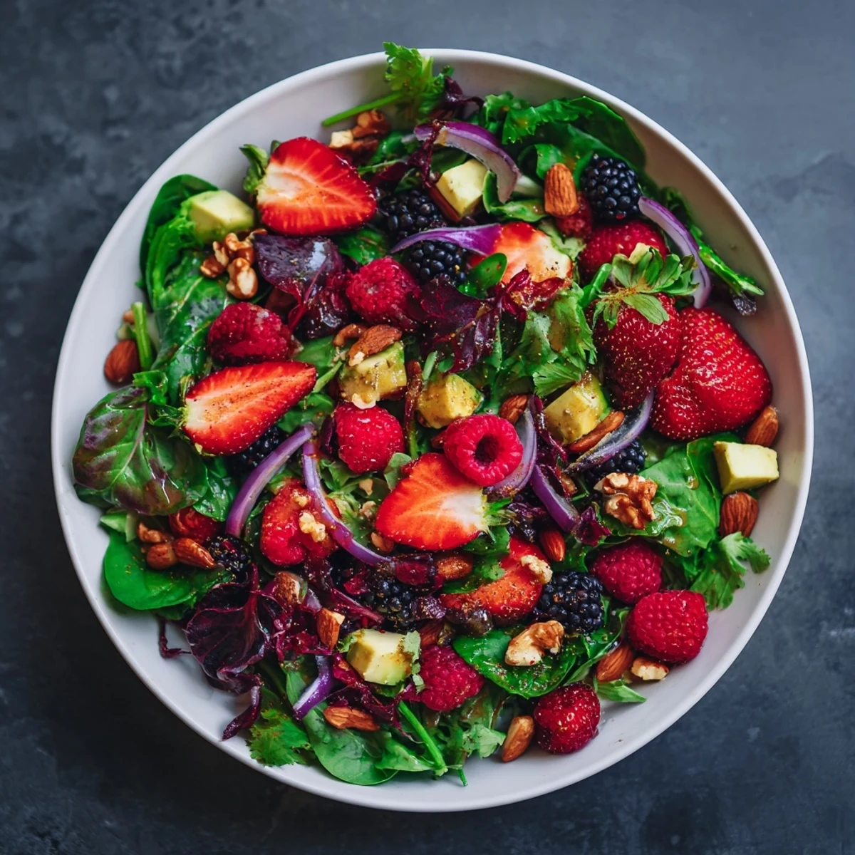 Vibrant vegan berry salad bursting with color, offering a refreshing medley of fresh fruit and greens.