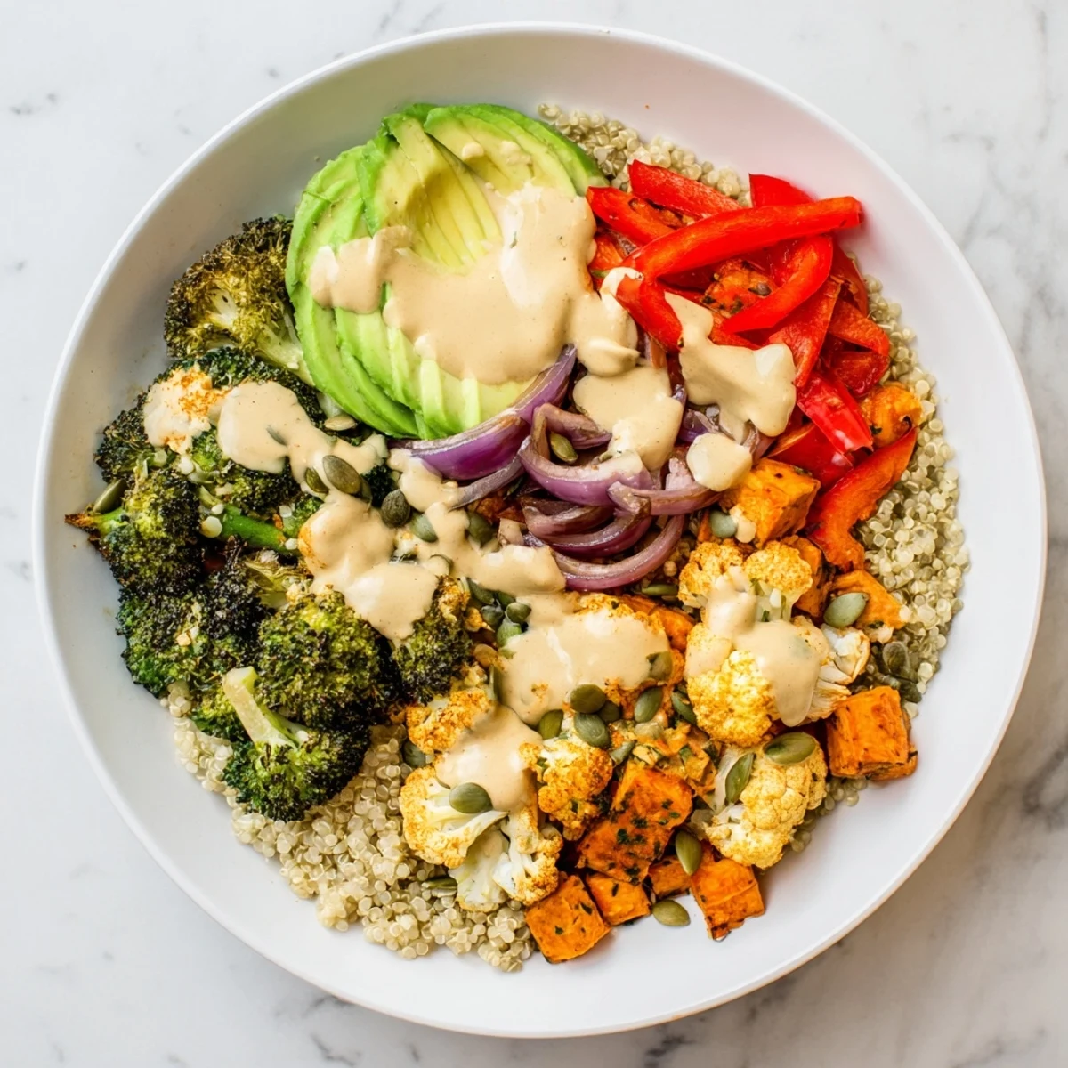 Steaming bowl of warm veggie bowl with roasted sweet potatoes and vibrant tahini drizzle.