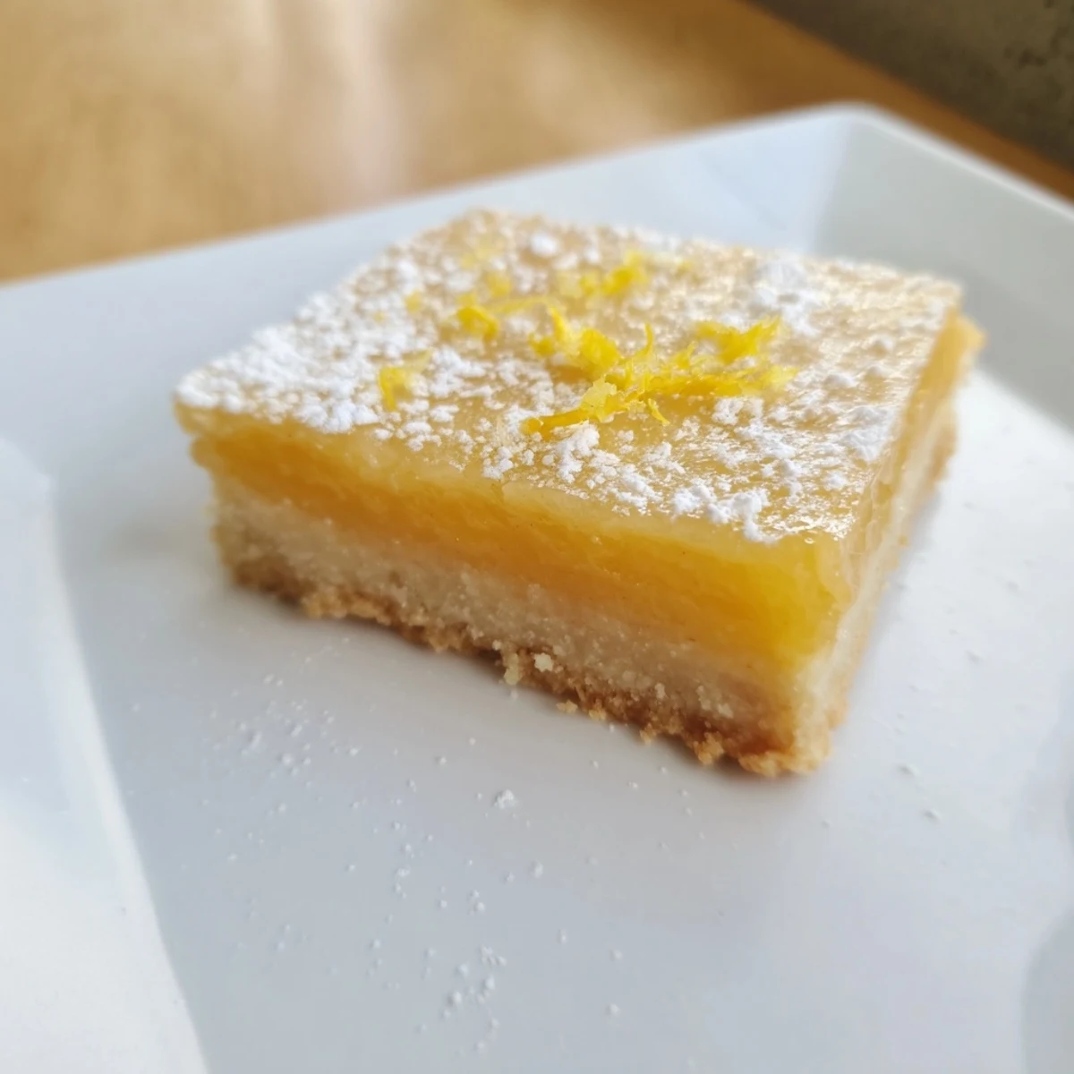 Close-up of baked vegan citrus bars, a sunny dessert perfect for sharing at a springtime picnic.