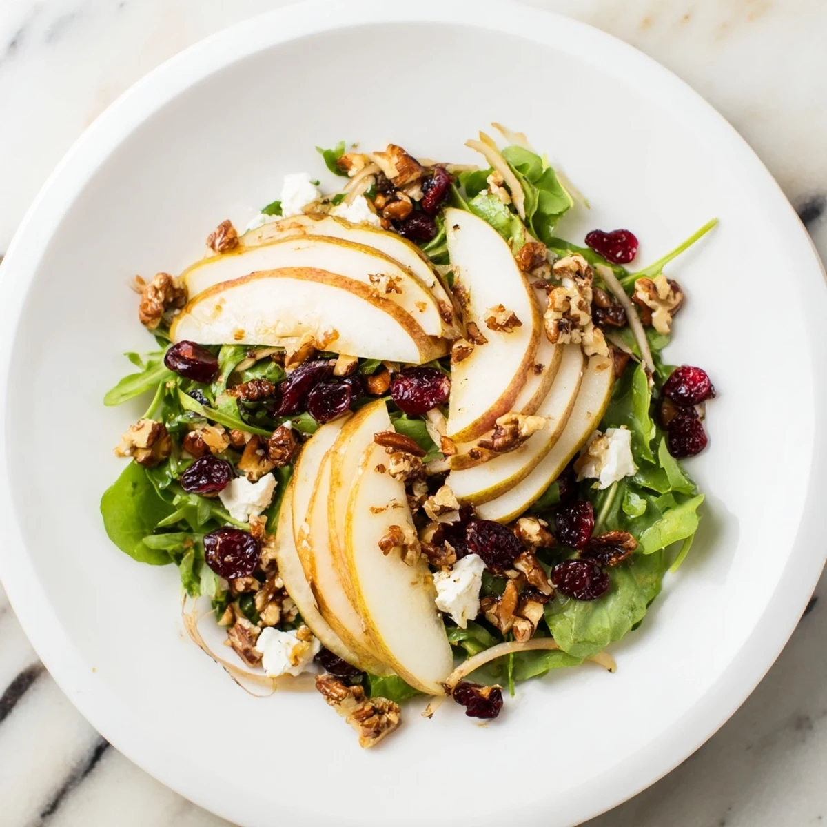 A colorful Bright Pear Salad with toasted walnuts and tangy honey-lemon dressing, delightful and eye-catching.