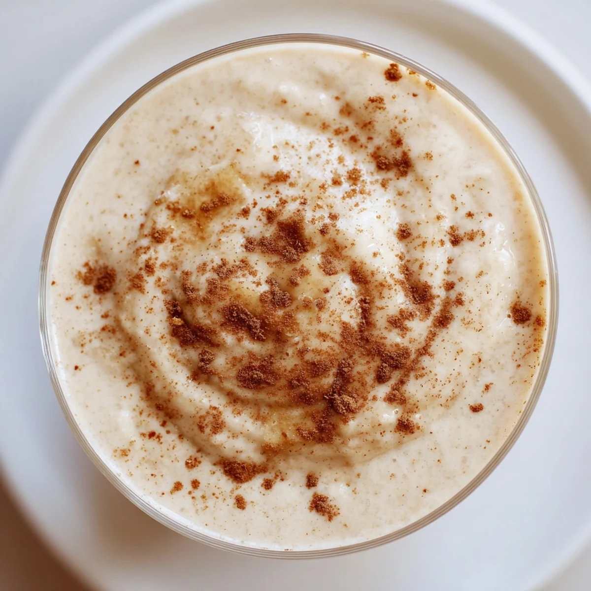 Glass of Winter Maple Smoothie on ice: a comforting blend of cinnamon and sweet maple flavor.