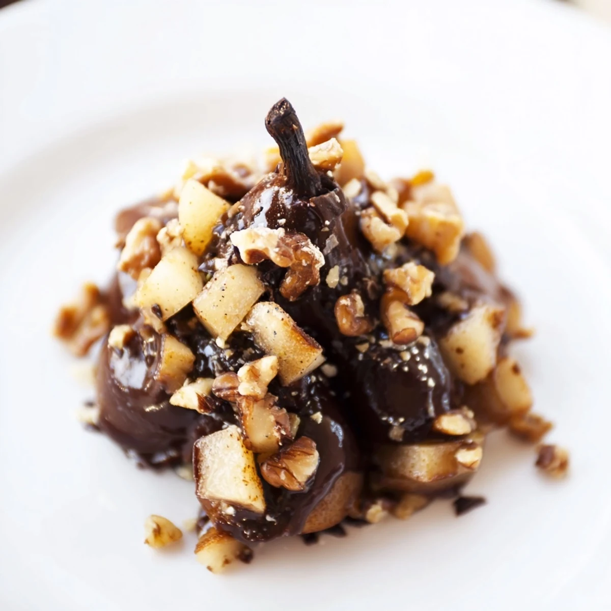 Twelve Seasonal Pear Clusters arranged on parchment, showcasing chopped pears and toasted pecans glistening with melted chocolate for an elegant treat.