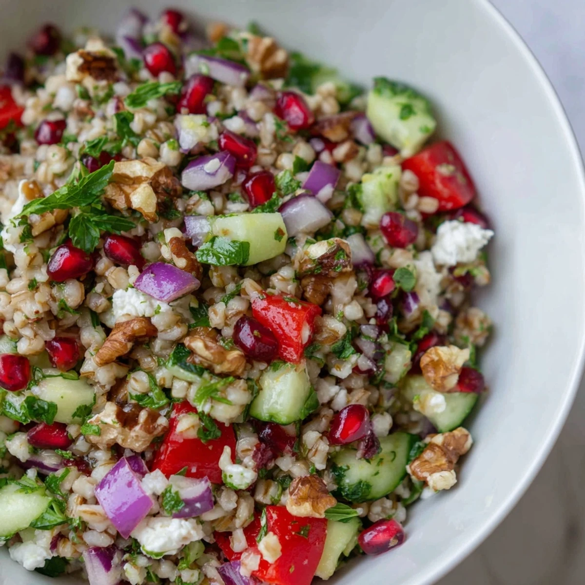 Crumble feta and toasted walnuts over this Festive Oat Salad for a crunchy, savory bite.