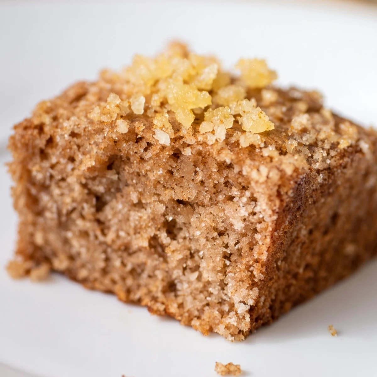 Fresh Ginger Bars sliced into squares with warm spices and a tender crumb, garnished with crystallized ginger.