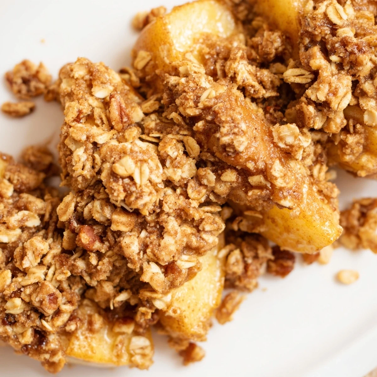 Fifteen warm Winter Apple Bites sit on a baking sheet with golden oat crumble, ready to eat.