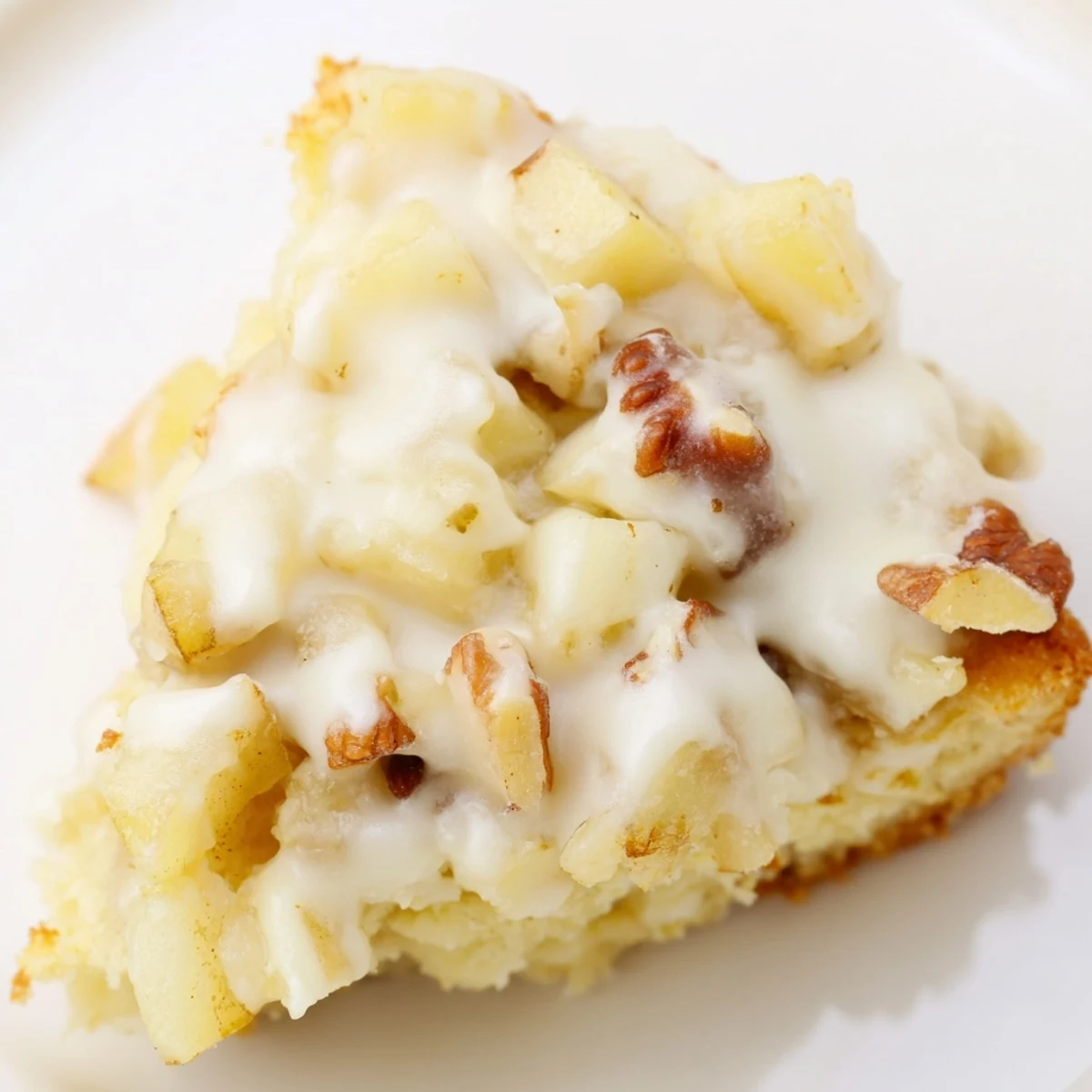 Warm Frosted Apple Cookies topped with thick vanilla frosting, ready to serve with milk.