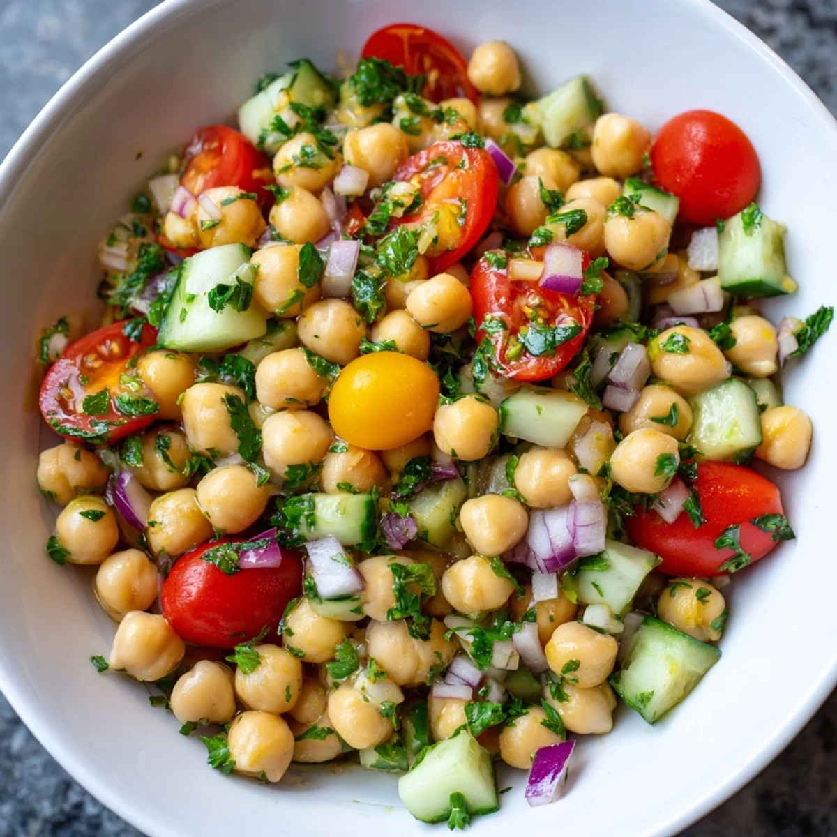 A vibrant Fresh Chickpea Salad with fresh parsley, drizzled with olive oil and lemon juice for a light lunch.