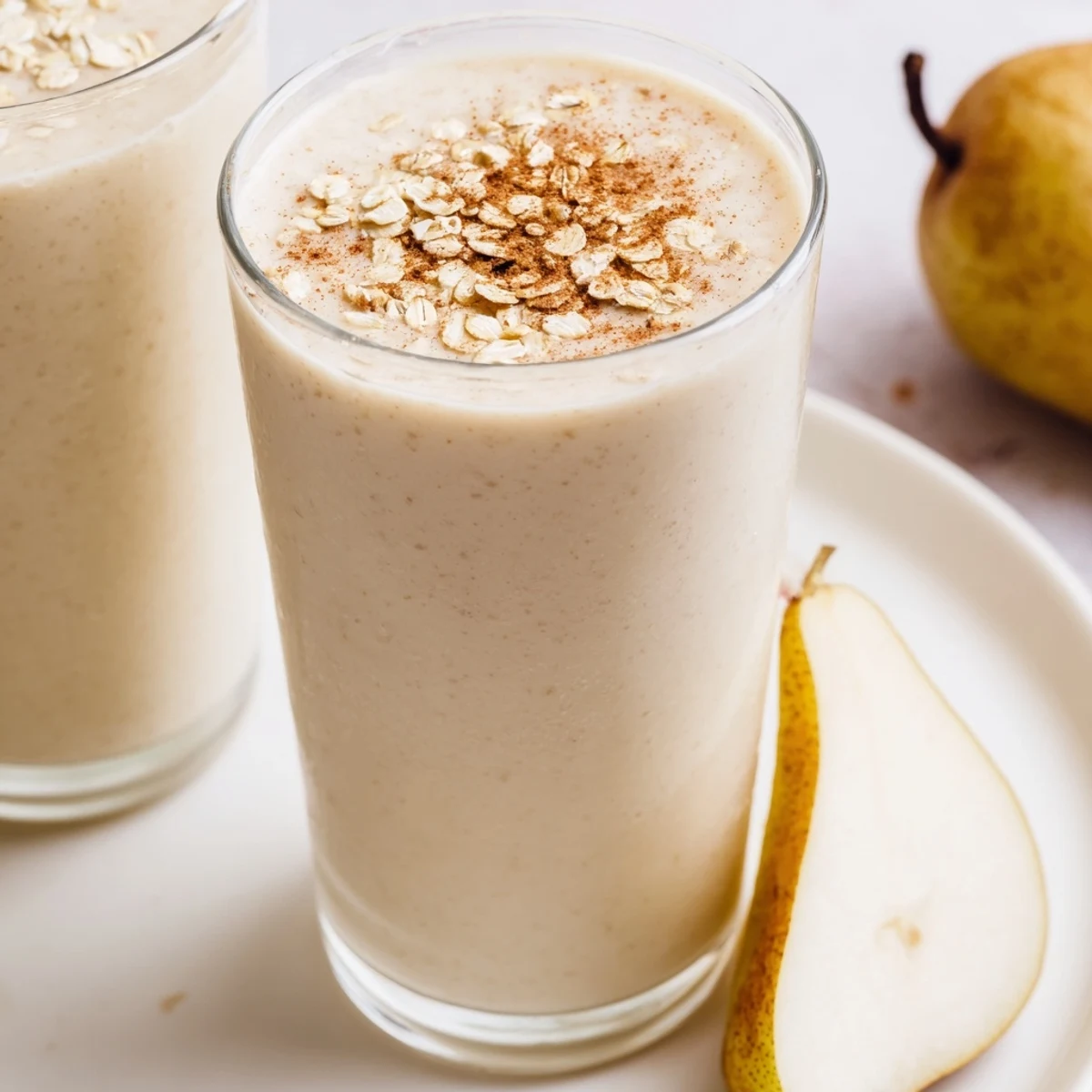 Whipped Cozy Pear Smoothie with Greek yogurt, showing a creamy texture and sweet aroma in a mason jar.