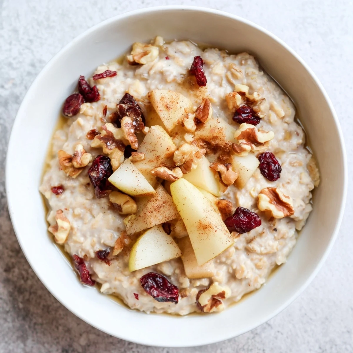 Hearty bowl of Festive Pear Porridge featuring tender pears and spices, served warm for chilly mornings.