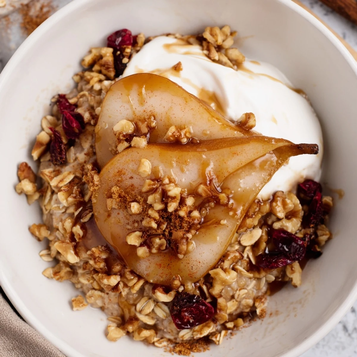 Golden caramelized pears glisten over creamy spiced oats in this cozy breakfast bowl recipe.