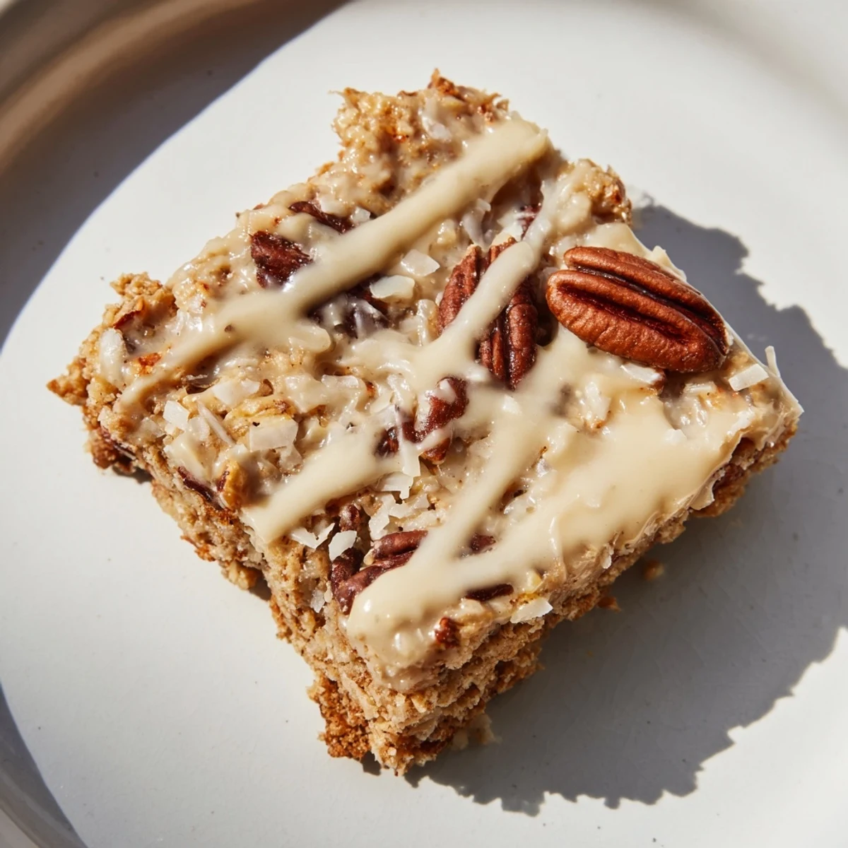 Golden-brown Fresh Maple Bites topped with a creamy maple glaze, arranged on a rustic wooden cutting board.