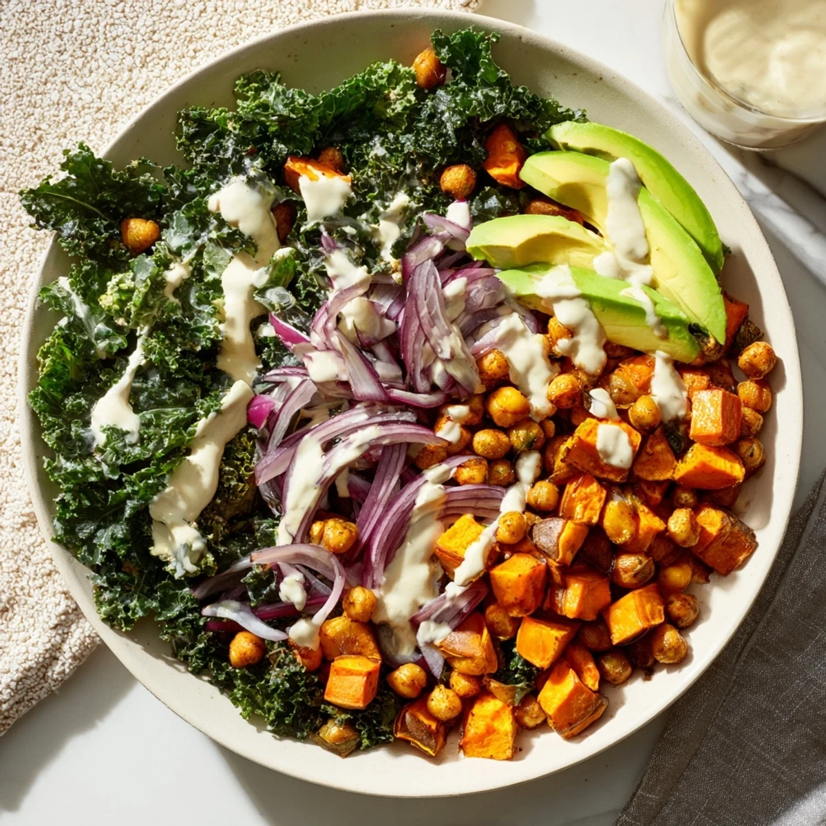 A close-up of a Cozy Kale Bowl features fluffy quinoa, bright green kale, and creamy avocado slices ready for a wholesome vegan dinner.  