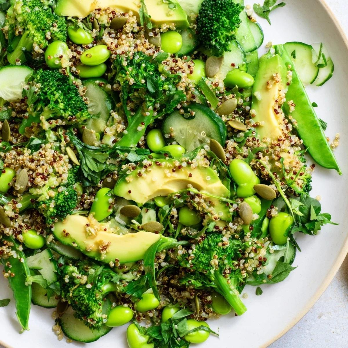Fresh quinoa and vibrant greens in the Wholesome Green Bowl served with snap peas, cucumber, and hemp seeds for a nourishing vegan meal.