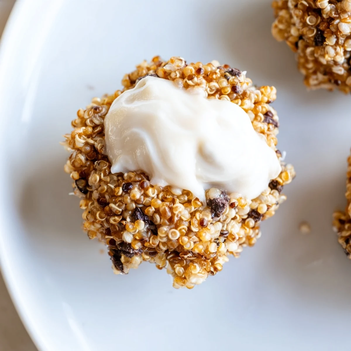 Frosted Quinoa Bites arranged neatly on a white plate, ready to serve as a healthy dessert.  