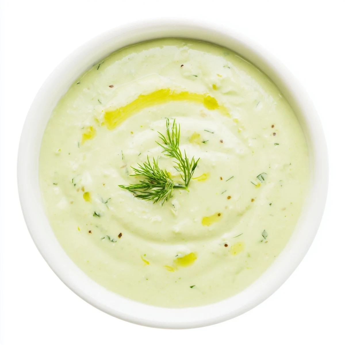 A vibrant bowl of Chilled Cucumber Avocado Soup garnished with fresh dill and a lime wedge on a rustic table.