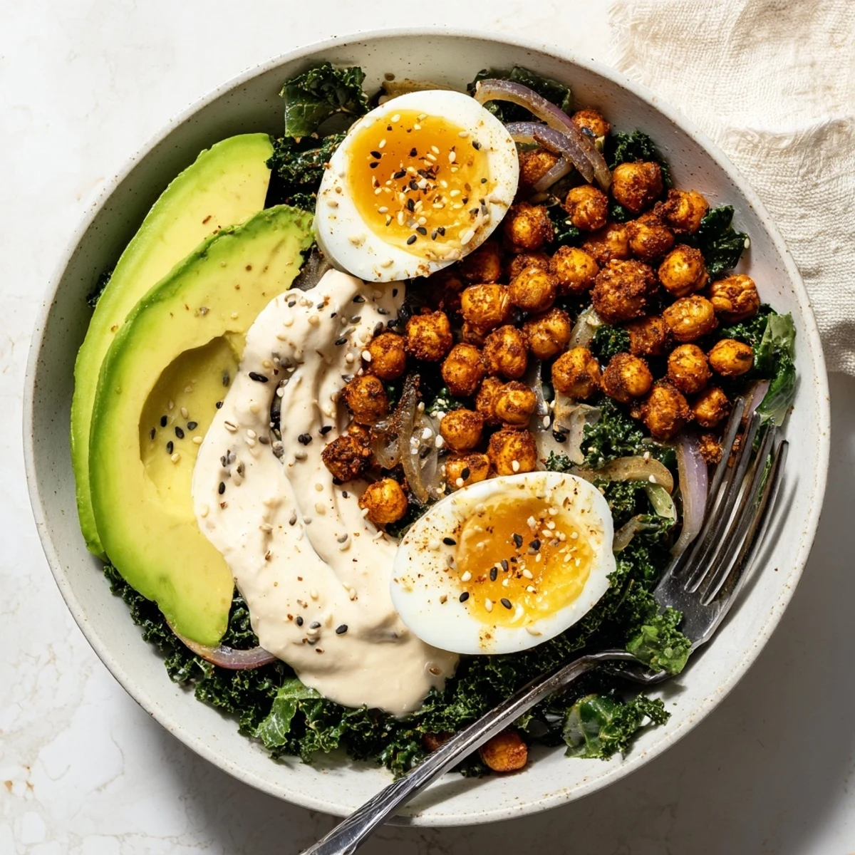 Vibrant sautéed kale and golden crispy chickpeas create texture in the Savory Tahini Kale Breakfast Bowl with Crispy Chickpeas