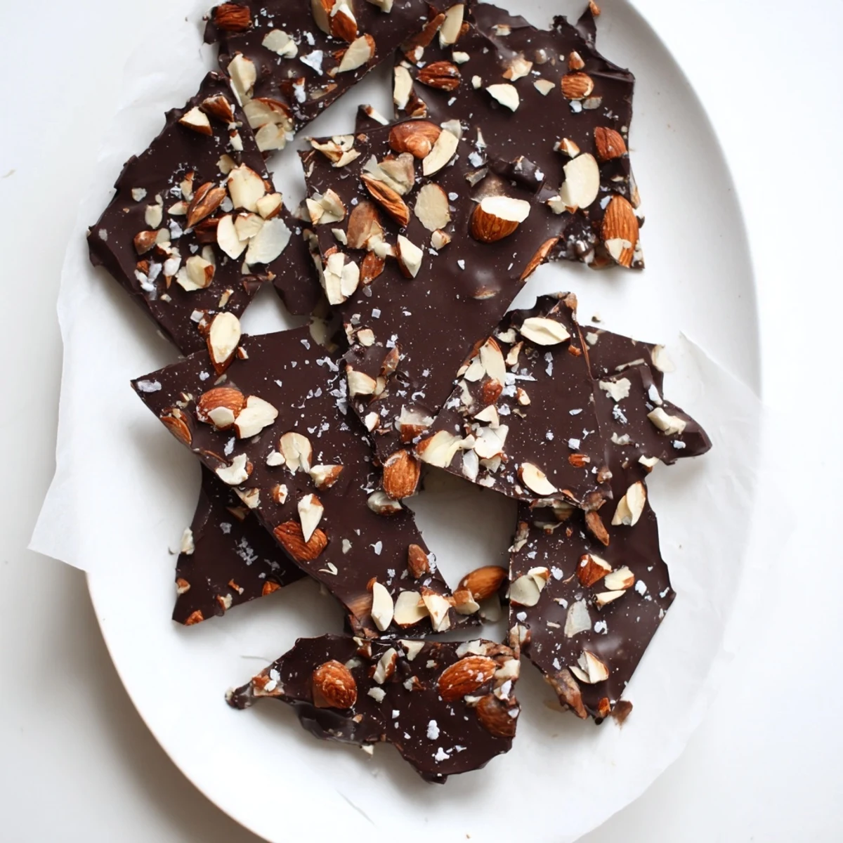 Dark chocolate salted almond freezer bark with crunchy toasted nuts and flaky sea salt topping
