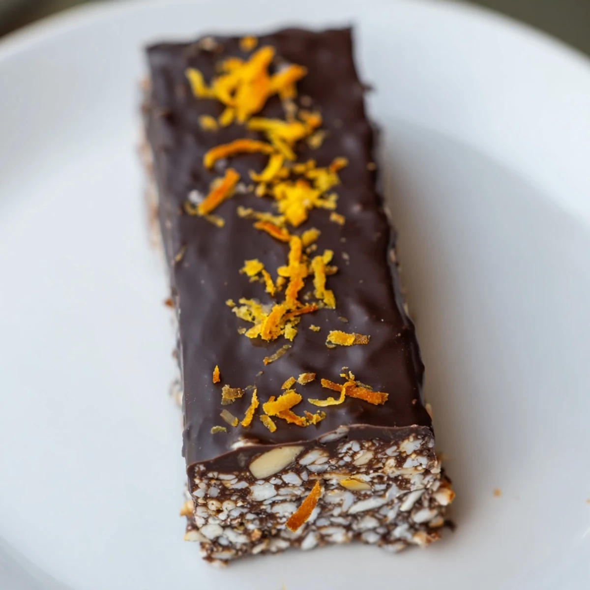 No-bake chocolate orange coconut bliss squares sliced on a white serving plate