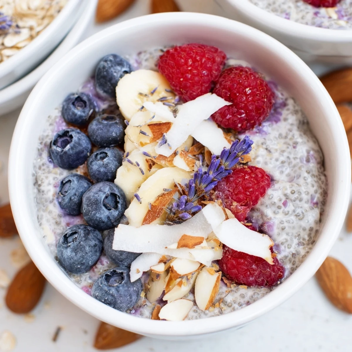 Overnight chia pudding bowl with lavender vanilla layered with nuts and coconut flakes