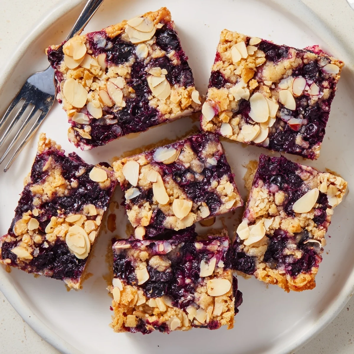 Fresh baked blueberry almond crumble bars featuring tender crust and toasted almond crunch on top