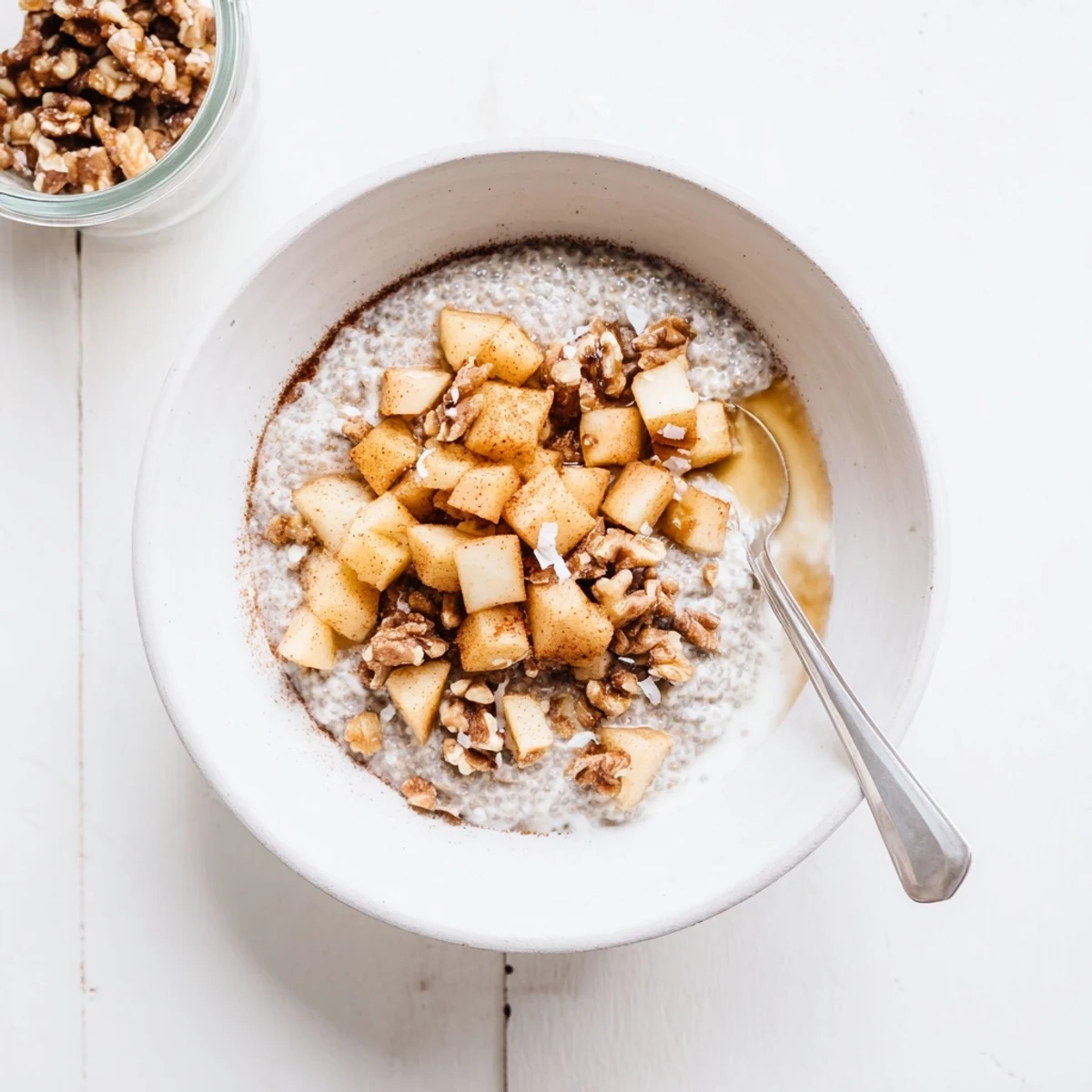 Creamy cinnamon apple chia overnight breakfast bowl topped with warm spiced apples and crunchy walnuts