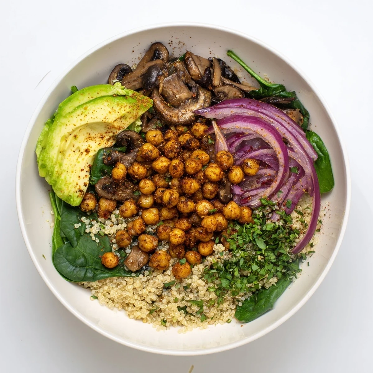 Hearty savory garlic mushroom chickpea breakfast bowl served in a white ceramic dish