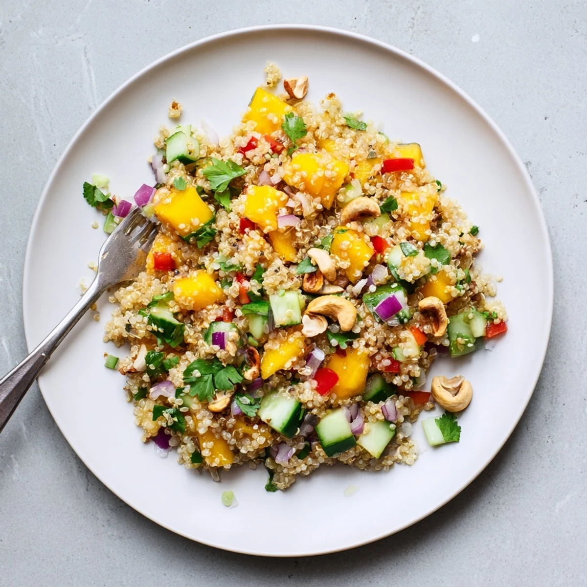 Vibrant summer bowl with smoky grilled mango, fluffy quinoa, crisp peppers, and spicy chili-lime dressing topping