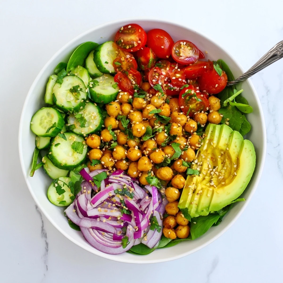 Golden sautéed chickpeas atop fresh spinach in this savory lemon garlic breakfast bowl