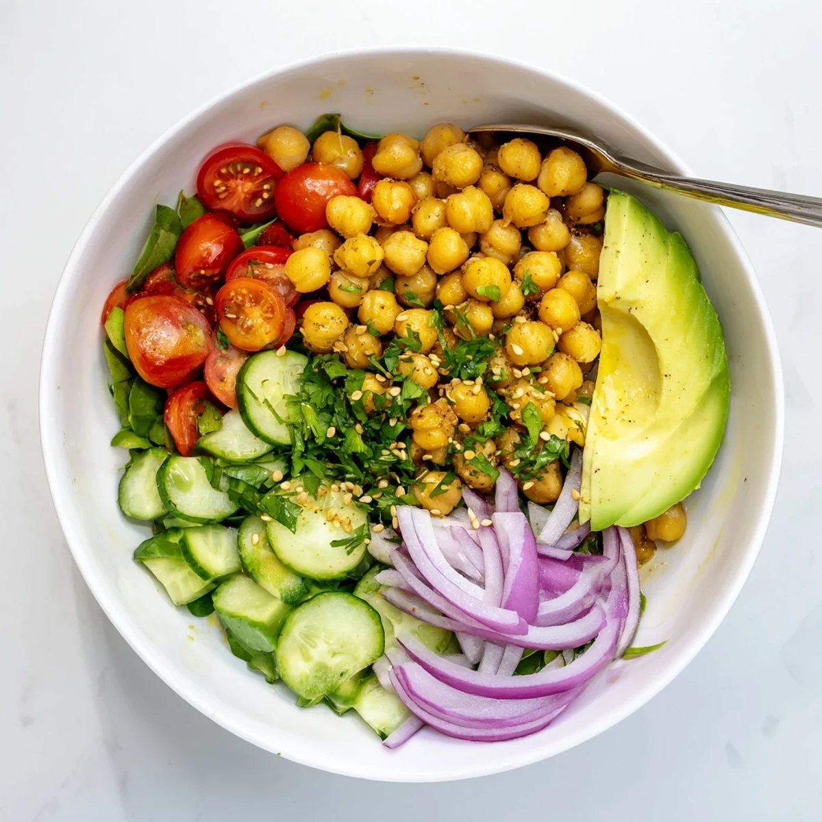 Colorful Mediterranean breakfast bowl with creamy avocado and zesty lemon garlic chickpeas