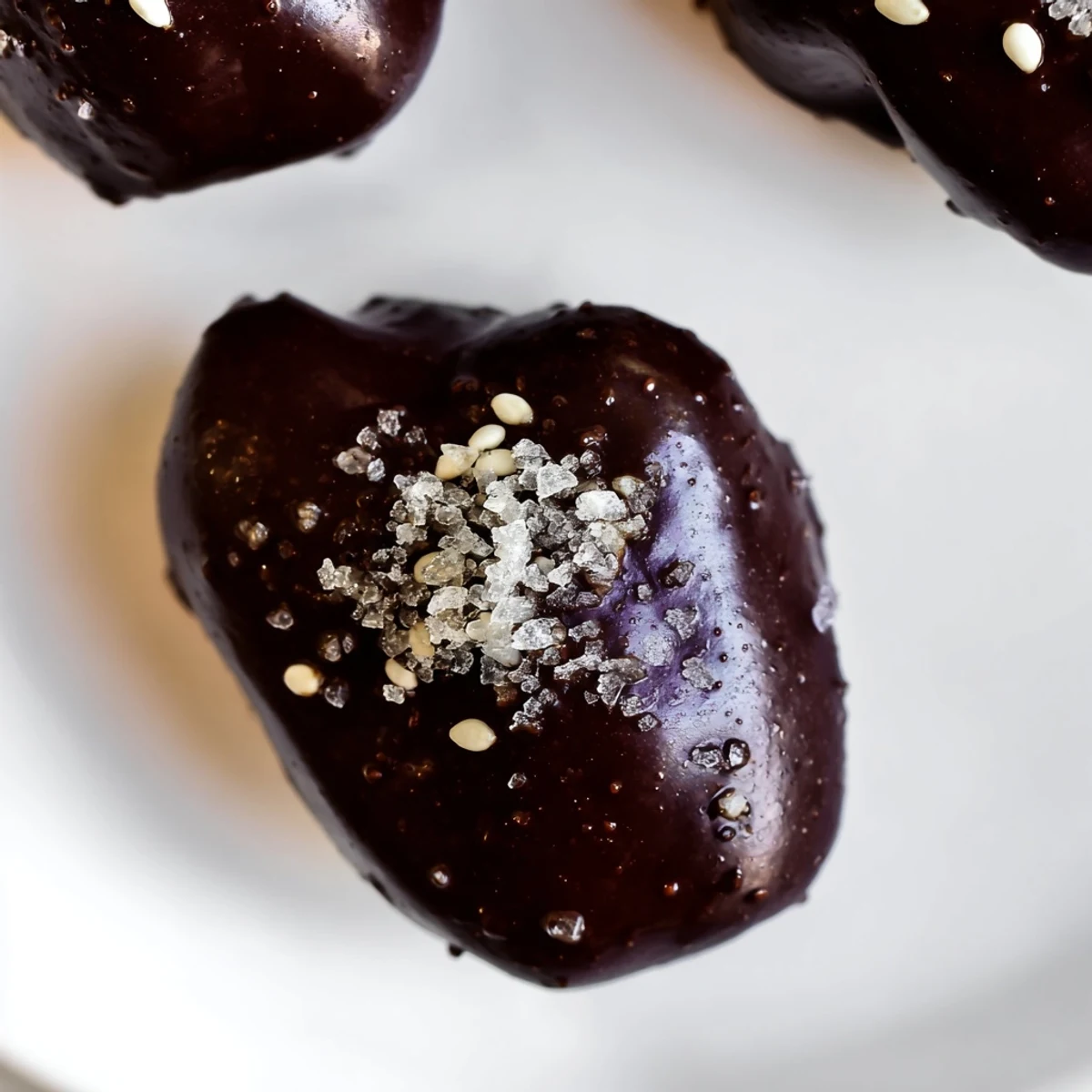 Homemade dark chocolate sesame date clusters arranged on parchment paper ready for healthy snacking