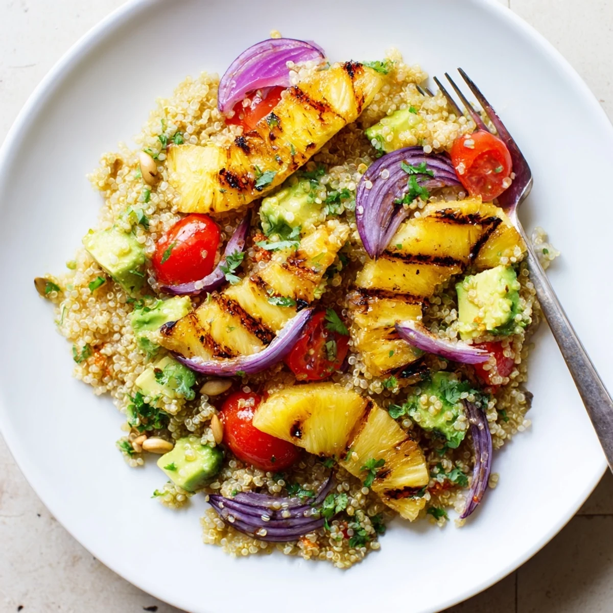 Charred sweet pineapple and fresh herbs in Grilled Pineapple Cilantro Quinoa Grain Salad