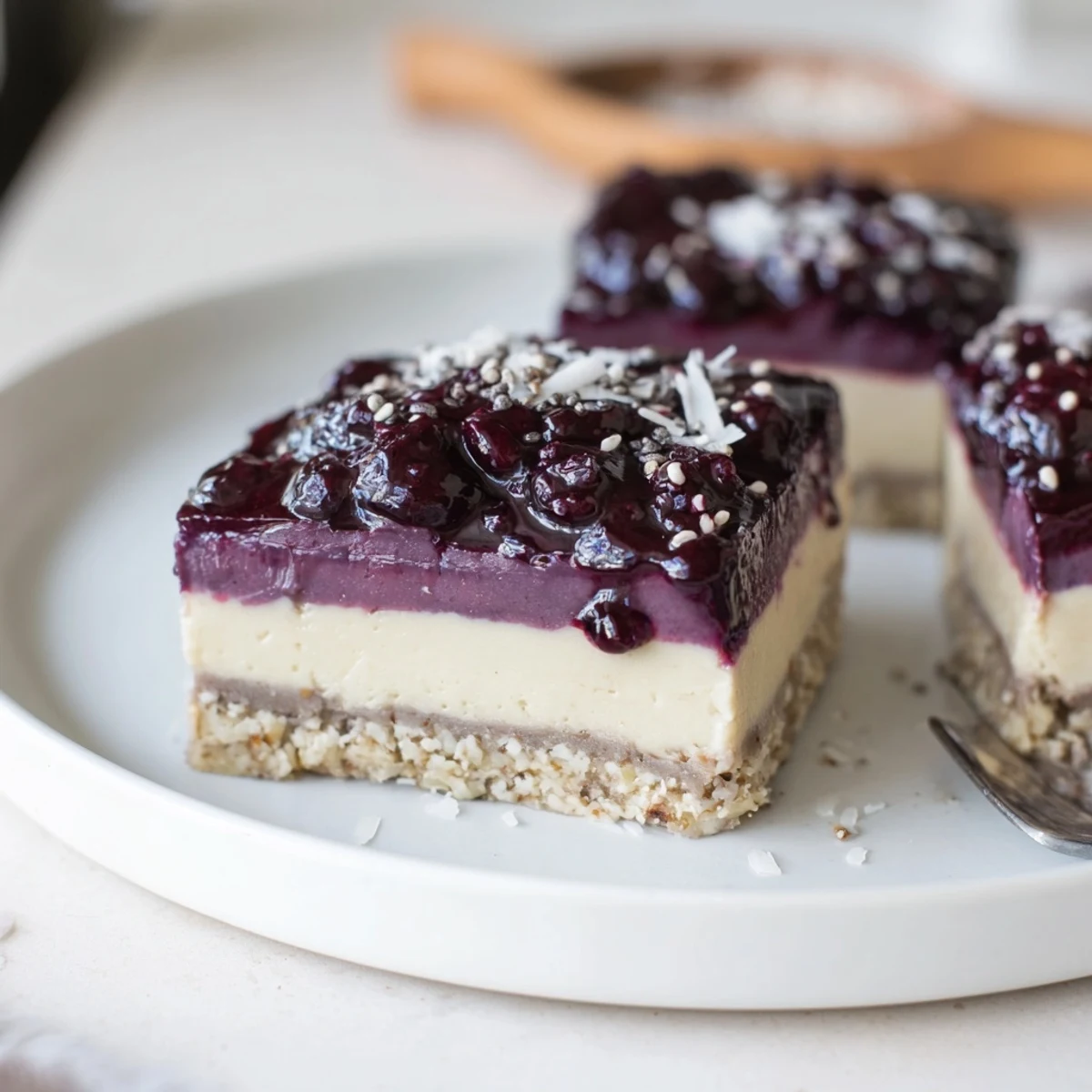 Blueberry Vanilla Cashew Cream Bars served chilled, topped with fresh berries and lemon zest.