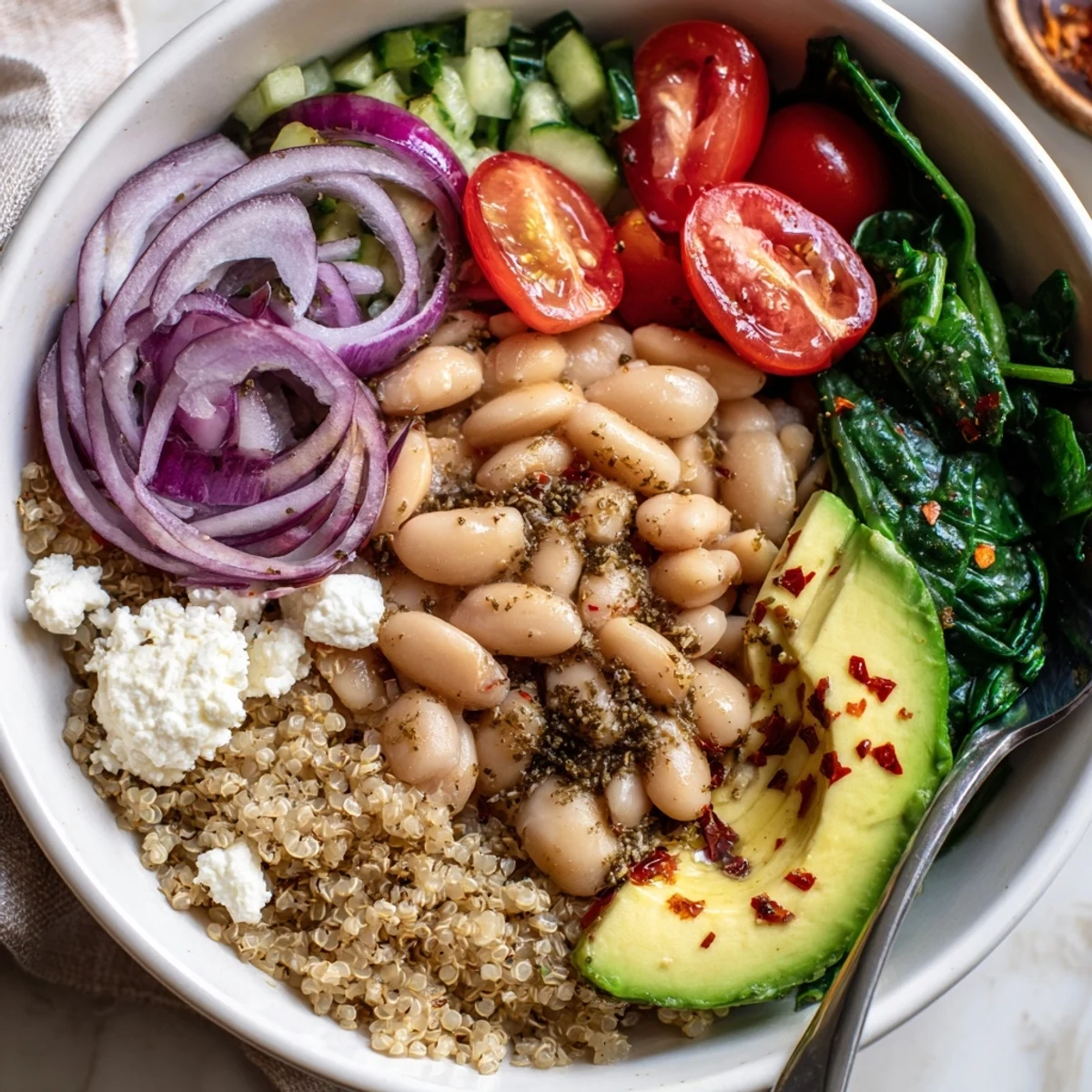 Warm Savory Zaatar White Bean Breakfast Bowl topped with crumbled feta, fresh herbs