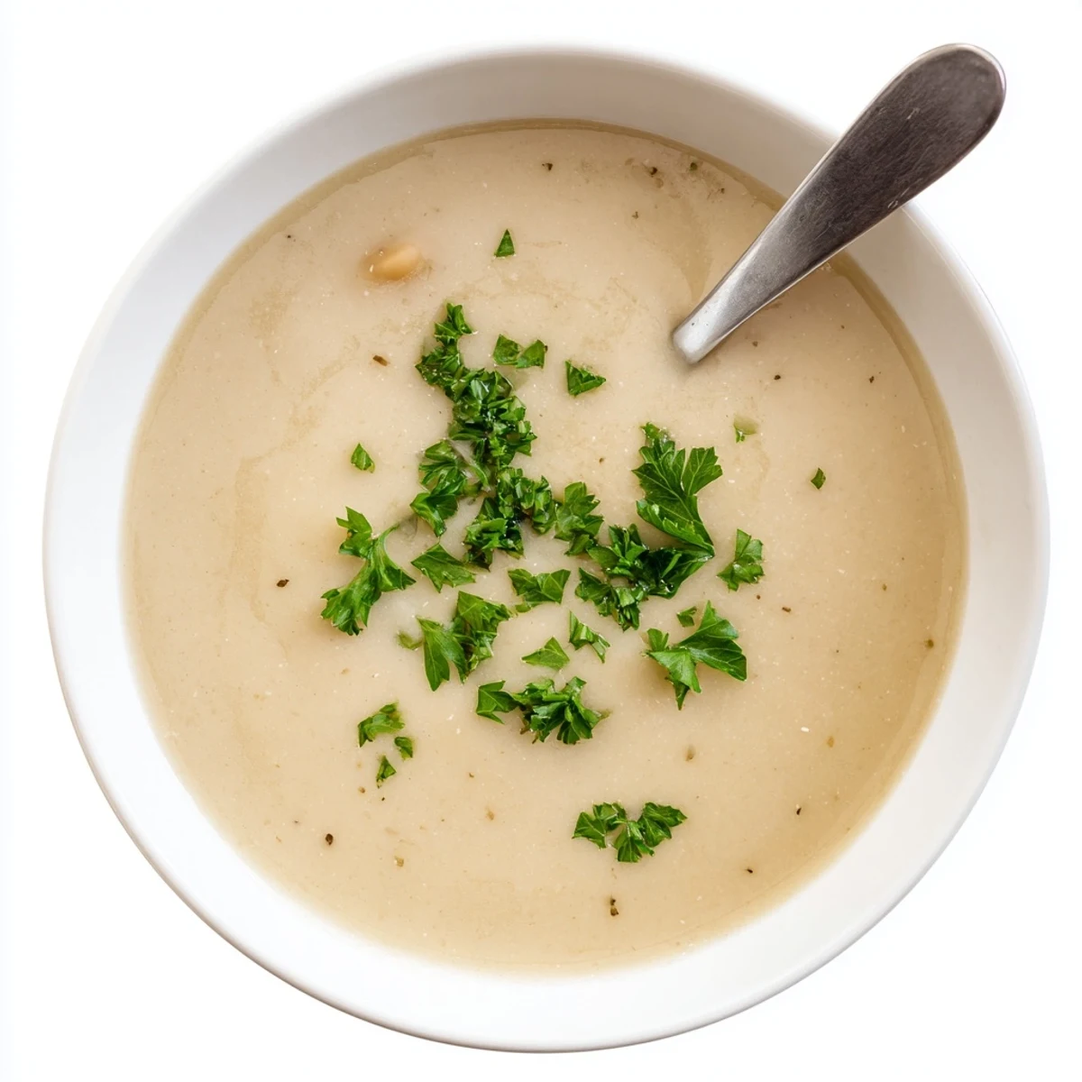 Creamy roasted shallot and white bean soup in a rustic bowl topped with fresh green parsley