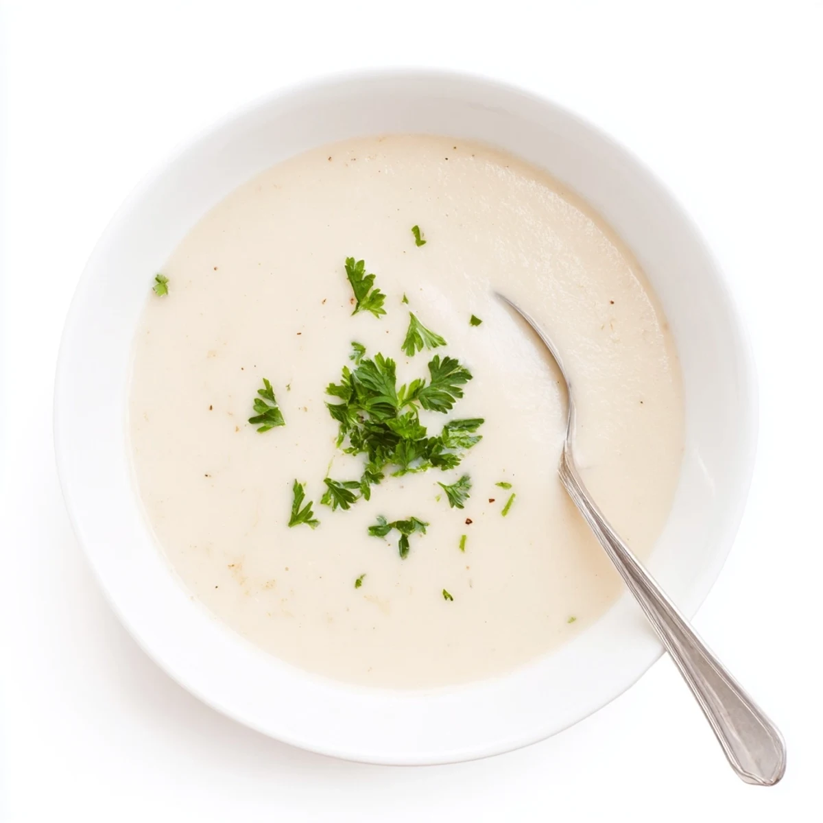 Velvety white bean soup with sweet caramelized shallots and a drizzle of cream