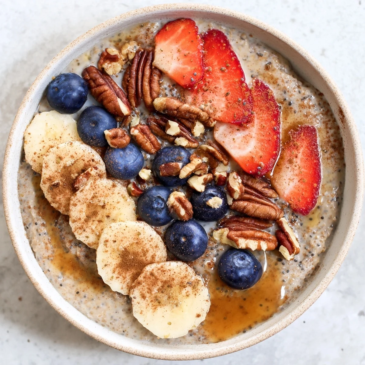 Wholesome buckwheat breakfast bowl drizzled with maple syrup and sprinkled with chia seeds, nuts, and fresh seasonal berries