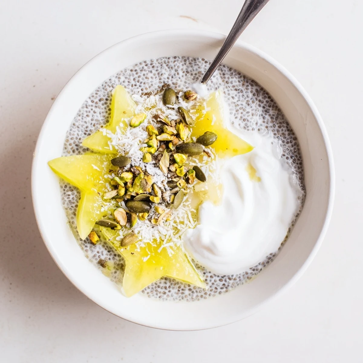 Starfruit Coconut Lime Chia Breakfast Bowl topped with sliced starfruit and shredded coconut