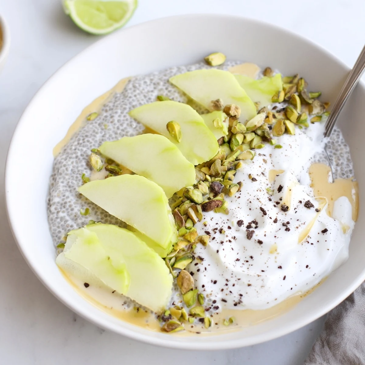 Creamy Starfruit Coconut Lime Chia Breakfast Bowl served chilled with chopped pistachios