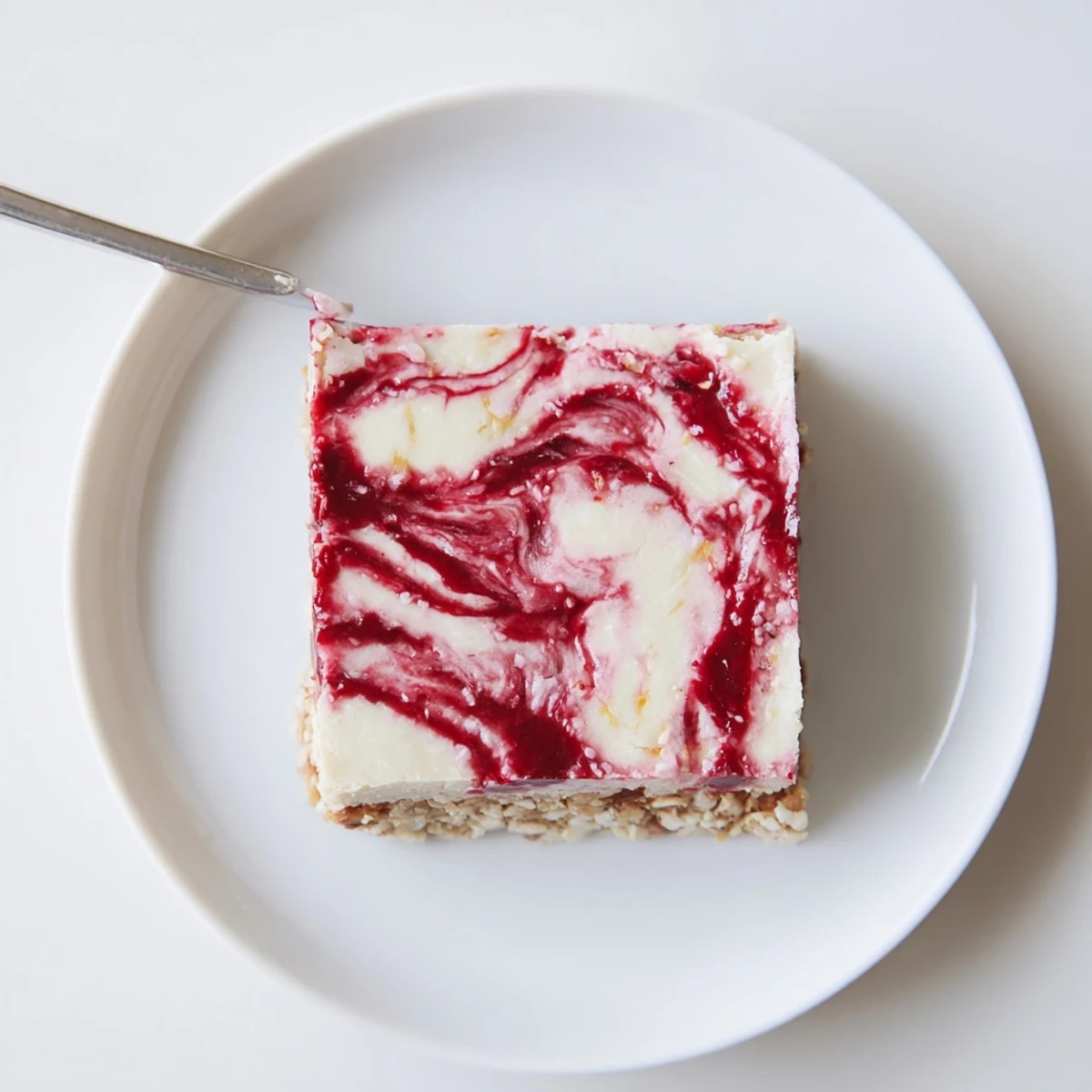 Sliced Raspberry Vanilla Cashew Cream Squares showcasing nutty crust and silky filling