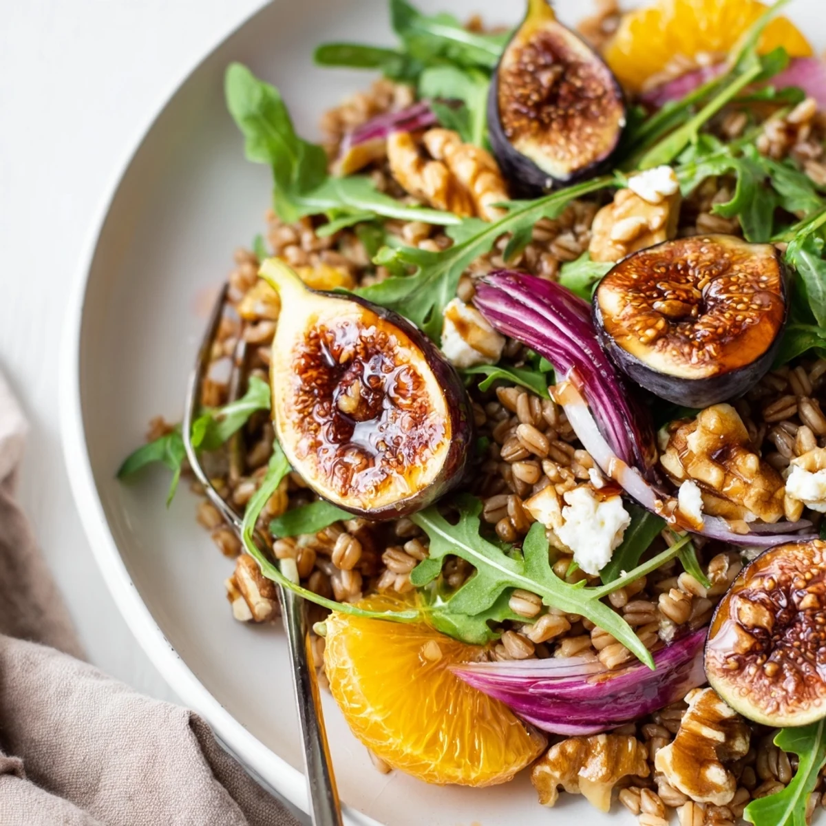 Warm Roasted Fig Orange Farro Grain Salad tossed with arugula, crunchy toasted walnuts
