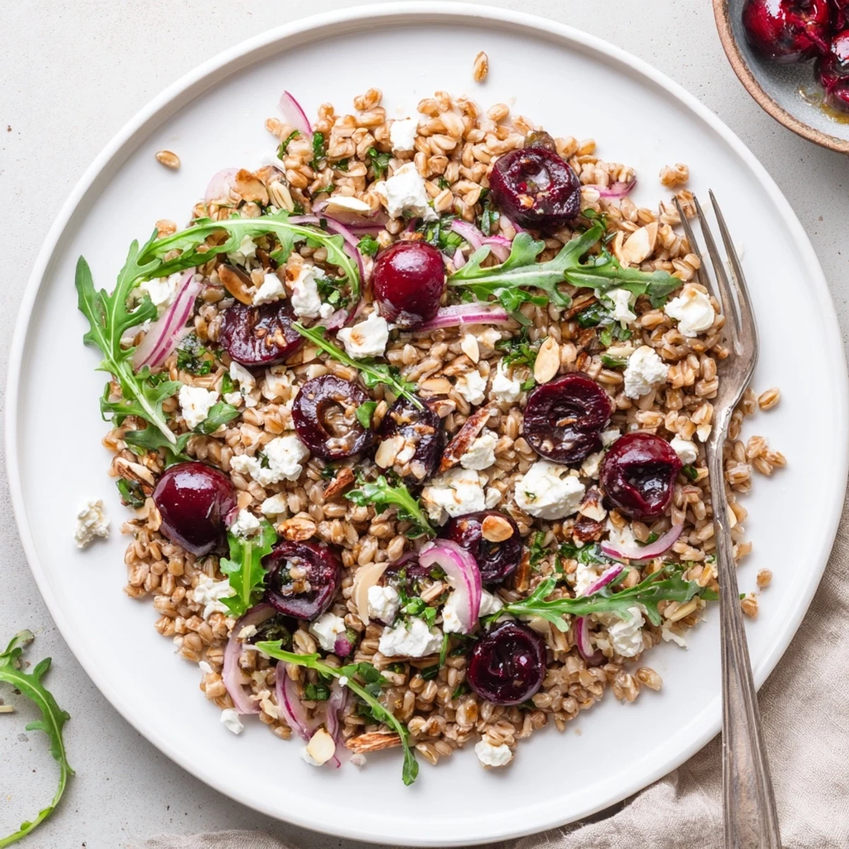 Roasted Cherry Balsamic Farro Grain Salad served warm, peppered arugula and herbs